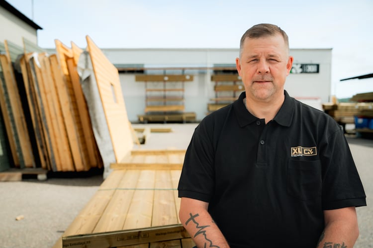 Bild på en man framför träfasader